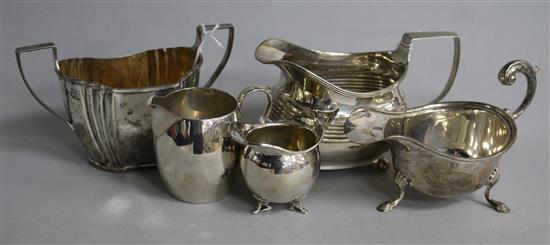 A George III silver oval cream jug, three other silver cream jugs, various and a silver sugar bowl (5)
